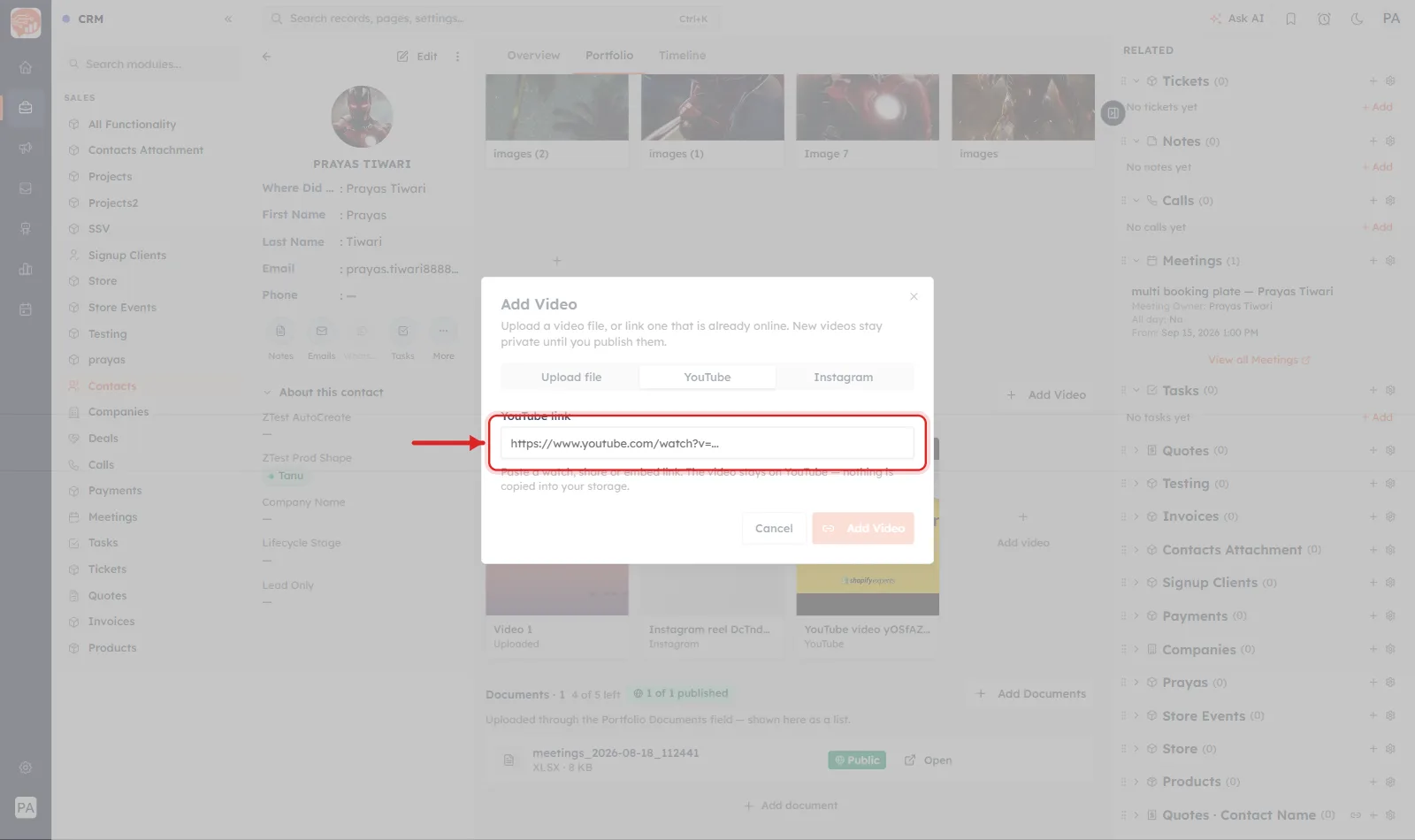 The Add Video dialog on its YouTube tab with the YouTube link box ringed in red and an arrow pointing at it. The help line beneath reads that the video stays on YouTube and nothing is copied into your storage.