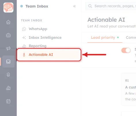 A close-up of the Team Inbox sidebar in AiEngage CRM. A red rounded rectangle rings the fourth menu entry, Actionable AI, shown in orange with a small thermometer icon, and a red arrow points at it from the right. Above it, dimmed, are the other three Team Inbox entries: WhatsApp with a speech-bubble icon, Inbox Intelligence with a sparkle icon, and Reporting with a bar-chart icon, under the section label TEAM INBOX. To the right, dimmed, is the beginning of the Actionable AI page with its heading and the Lead priority tab.